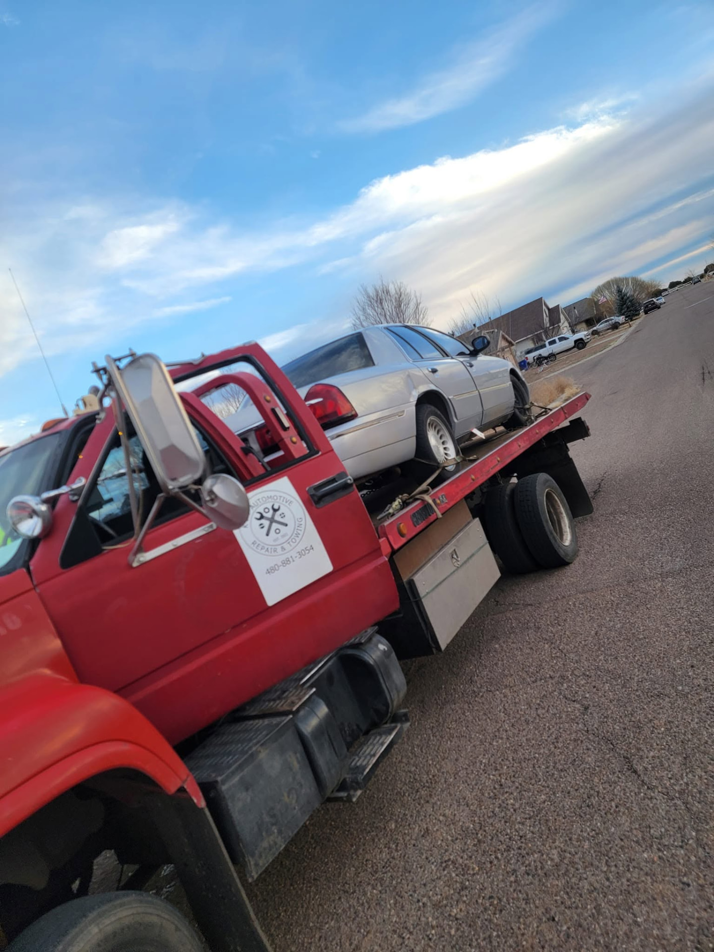 Sedan strapped down on the K&P flatbed tow truck in Arizona
