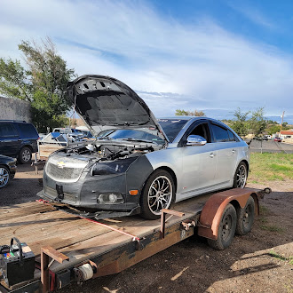 Chevy sedan loaded on a trailer for transport to the K&P shop